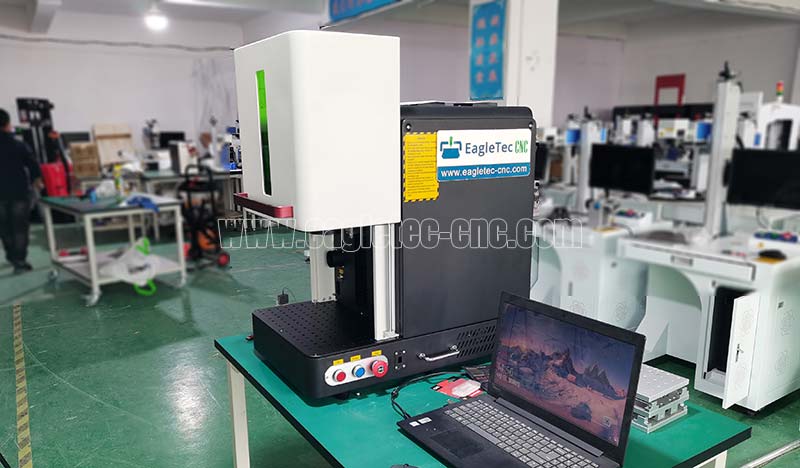 tabletop 50w fiber laser engraver with protection enclosure on the table